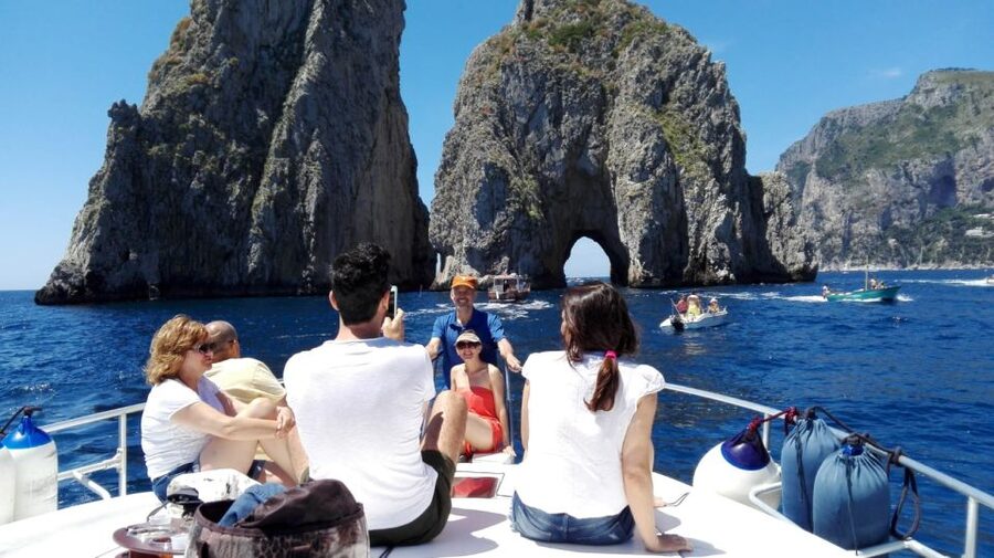 From Sorrento: Capri Boat Trip with Snorkeling and Drinks - The return trip: Faraglioni tunnels, famous villas, and Spritzoncello on the water