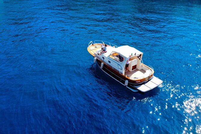 Luxury private boat tour to Capri and Blue Grotto on Gozzo 32 ft - I Faraglioni and the Natural Arch: seeing Capri’s icons from sea level